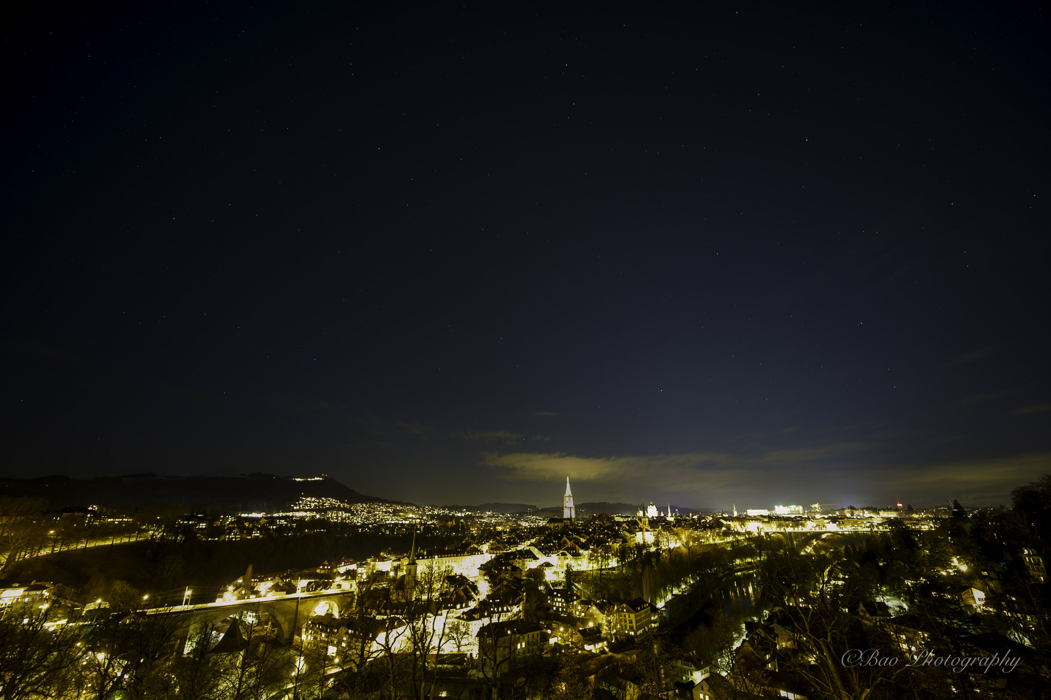 Night panorama of Bern from the Rosengarten with the illuminated Münster cathedral and the Gurten hill in the distance
